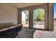 Covered patio with stone pavers and outdoor seating area overlooking the front walkway at 11856 Barona Mesa Ave, Las Vegas, NV 89138