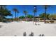 Sandy volleyball court with palm trees, inviting residents for outdoor recreation and friendly matches at 11856 Barona Mesa Ave, Las Vegas, NV 89138