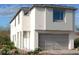 Modern two-story home with a gray garage door and white stucco exterior at 11881 Pied Harrier Ave, Las Vegas, NV 89138