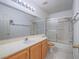 Bathroom featuring a shower-tub combo and a wooden vanity with white countertop at 1424 Heartstring Ct, Henderson, NV 89002
