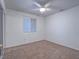 Comfortable bedroom featuring a ceiling fan and a bright window at 1424 Heartstring Ct, Henderson, NV 89002