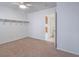 Empty bedroom with neutral carpet, shelving, and view into another room at 1424 Heartstring Ct, Henderson, NV 89002