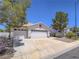 Charming home featuring a spacious driveway, two-car garage, and desert-friendly landscaping at 1424 Heartstring Ct, Henderson, NV 89002