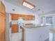 Bright kitchen features white appliances, tile floors and backsplash, light wood cabinetry, and an island with granite countertops at 1424 Heartstring Ct, Henderson, NV 89002