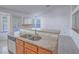 Kitchen island features granite countertops, a stainless steel sink, and wood cabinetry at 1424 Heartstring Ct, Henderson, NV 89002