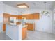 Bright kitchen with white appliances, light wood cabinetry, granite countertops, and tile floors at 1424 Heartstring Ct, Henderson, NV 89002