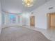 Inviting living room with carpet, large windows, and neutral paint at 1424 Heartstring Ct, Henderson, NV 89002