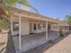 Enjoy this covered patio, perfect for outdoor dining and relaxation, surrounded by desert landscaping at 1424 Heartstring Ct, Henderson, NV 89002