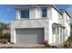 Modern two-story home with attached garage, white stucco exterior, and desert landscaping at 1555 Pacific Baza St, Las Vegas, NV 89138