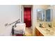 Compact bathroom with a single sink vanity, tiled floor, and a shower with a red privacy curtain at 1745 Walingwood Dr, North Las Vegas, NV 89031