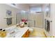 Well-lit bathroom with shower-tub combination, single sink vanity, and decorative accents at 1745 Walingwood Dr, North Las Vegas, NV 89031