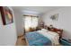 Cozy bedroom featuring a patterned window curtain, framed wall art, and a comfortable bed at 1745 Walingwood Dr, North Las Vegas, NV 89031