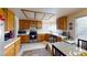 Bright kitchen with wood cabinets, white countertops, stainless steel appliances, and a dining area at 1745 Walingwood Dr, North Las Vegas, NV 89031