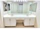 Well-lit bathroom featuring a double sink vanity, modern fixtures, and a large mirror at 2035 E Warm Springs Rd # 1017, Las Vegas, NV 89119