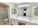 Bathroom boasting a double sink vanity, a large mirror, and walk-in shower at 2035 E Warm Springs Rd # 1017, Las Vegas, NV 89119