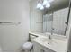 Bathroom featuring a sink, toilet, and a well-lit mirror with modern fixtures at 2035 E Warm Springs Rd # 1017, Las Vegas, NV 89119