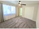 Bright bedroom with neutral carpet, ceiling fan, closet, and light-filled window at 2035 E Warm Springs Rd # 1017, Las Vegas, NV 89119