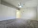 Spacious bedroom featuring plush carpet, a ceiling fan, and multiple closets at 2035 E Warm Springs Rd # 1017, Las Vegas, NV 89119