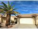 A well-kept home with a two-car garage and mature palm tree providing shade and curb appeal at 2035 E Warm Springs Rd # 1017, Las Vegas, NV 89119