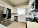Modern kitchen with stainless steel appliances, white cabinets, and a stylish tiled backsplash at 2035 E Warm Springs Rd # 1017, Las Vegas, NV 89119