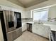 Bright kitchen featuring stainless steel appliances, white cabinetry, and a modern backsplash at 2035 E Warm Springs Rd # 1017, Las Vegas, NV 89119