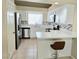 Updated kitchen featuring quartz counters, stainless appliances, and tile flooring at 2035 E Warm Springs Rd # 1017, Las Vegas, NV 89119