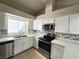 Well-equipped kitchen with quartz counters, stainless steel appliances, and tile backsplash at 2035 E Warm Springs Rd # 1017, Las Vegas, NV 89119