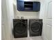 Laundry room featuring a modern washer and dryer with dark blue cabinets above at 2035 E Warm Springs Rd # 1017, Las Vegas, NV 89119