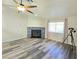 Bright living room featuring a fireplace, ceiling fan, and wood flooring at 2035 E Warm Springs Rd # 1017, Las Vegas, NV 89119