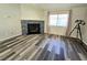 Bright living room featuring a fireplace, a large window, and wood flooring at 2035 E Warm Springs Rd # 1017, Las Vegas, NV 89119