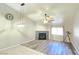 Open-concept living room featuring fireplace, ceiling fan, and wood flooring at 2035 E Warm Springs Rd # 1017, Las Vegas, NV 89119