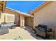 Cozy outdoor patio with seating, barbecue grill, and decorative plants under a sunny sky at 2035 E Warm Springs Rd # 1017, Las Vegas, NV 89119