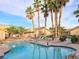 Inviting community pool area with lounge chairs and lush tropical landscaping, ideal for leisure and entertainment at 2035 E Warm Springs Rd # 1017, Las Vegas, NV 89119
