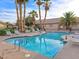 Enjoy this community pool, perfect for relaxation with lounge chairs and beautiful palm trees around at 2035 E Warm Springs Rd # 1017, Las Vegas, NV 89119