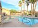 A community pool featuring lounge chairs, palm trees, and a hot tub for relaxation and recreation at 2035 E Warm Springs Rd # 1017, Las Vegas, NV 89119