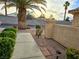 A stone walkway leading to the home, surrounded by manicured bushes and a mature palm tree at 2035 E Warm Springs Rd # 1017, Las Vegas, NV 89119