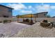 Expansive backyard featuring a brick patio, built in outdoor kitchen, and gravel landscaping at 2117 Leatherbridge Ct, North Las Vegas, NV 89081