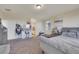An expansive bedroom with a vanity, upholstered bed, carpet and view of the ensuite bathroom at 2117 Leatherbridge Ct, North Las Vegas, NV 89081