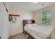 Cozy bedroom features a comfortable bed, closet, window with natural light, and decor at 2117 Leatherbridge Ct, North Las Vegas, NV 89081