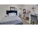 Cozy bedroom featuring a bed with plush bedding and a vanity desk at 2117 Leatherbridge Ct, North Las Vegas, NV 89081