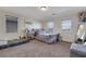 Spacious bedroom features a plush, gray bed set, a mirrored dresser, and lots of natural light at 2117 Leatherbridge Ct, North Las Vegas, NV 89081