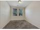 A neutral, carpeted bedroom features two windows with blinds and ample natural light at 2117 Leatherbridge Ct, North Las Vegas, NV 89081