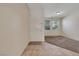 Neutral entryway featuring a tiled floor transitioning to carpet and a front door to the exterior at 2117 Leatherbridge Ct, North Las Vegas, NV 89081