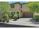 Inviting two-story home featuring a two-car garage and well-maintained front yard landscaping at 2117 Leatherbridge Ct, North Las Vegas, NV 89081