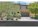 Charming home boasts a two-car garage and landscaped front yard with mature trees at 2117 Leatherbridge Ct, North Las Vegas, NV 89081