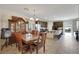 Open-concept kitchen and dining area featuring dark cabinetry, stainless appliances, and tile flooring at 2117 Leatherbridge Ct, North Las Vegas, NV 89081