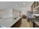 A kitchen showcases a large island, stainless steel appliances, and dark cabinetry extending into the dining area at 2117 Leatherbridge Ct, North Las Vegas, NV 89081
