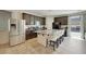 A kitchen has a large island with seating, stainless steel appliances, and dark wood cabinetry at 2117 Leatherbridge Ct, North Las Vegas, NV 89081