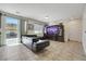 A living room boasts a view to an outdoor cooking space and showcases comfortable seating and a large entertainment center at 2117 Leatherbridge Ct, North Las Vegas, NV 89081