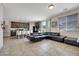 A living room displays an open layout with kitchen view and comfortable seating, enhanced by natural light at 2117 Leatherbridge Ct, North Las Vegas, NV 89081